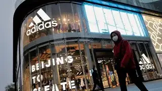 Adidas cuts outlook on supply logjam