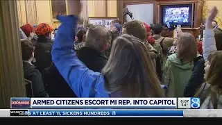 Armed activists escort Michigan lawmaker to work