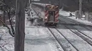 Commuter train smashes into car at snowy crossing
