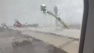 Delta plane being de-iced during winter storm