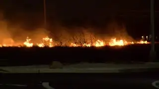 Fire crews battle grass fire near  Commodores and Aquarius