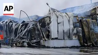 Firefighters battle flames after deadly explosion at cookie factory in Greece