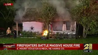 Firefighters battle massive house fire