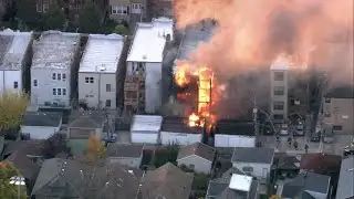 Firefighters battle raging flames at Albany Park building