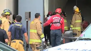 Firefighters free man trapped between buildings