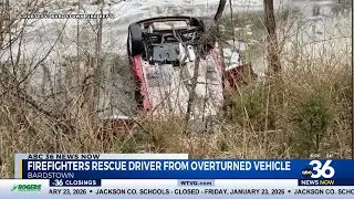 Firefighters rescue driver from overturned vehicle