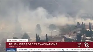 Forward spread stopped in Spring Valley brush fire; evacuation order shifted to warning