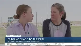 Girl scout plants trees at park