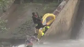 Helicopter crew rescues firefighters stranded when rescue boat goes over falls