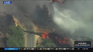 Helicopters extinguishing fire with water drops