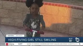 High-fiving girl still smiling