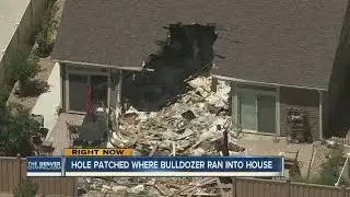 Hole patched where bulldozer ran into house