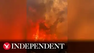 Huge flames tower over firefighters as blaze rips through Texas