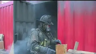 Local firefighters fight fires inside burn simulator