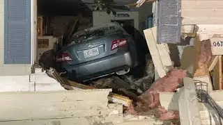 Man describes being pinned under car after vehicle crashes into home