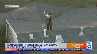 Man on roof throws objects at crews battling house fire in L.A. County