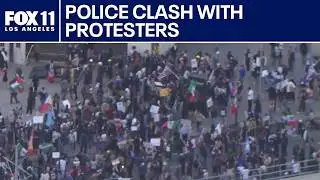 Police clash with anti-ICE protesters in downtown LA