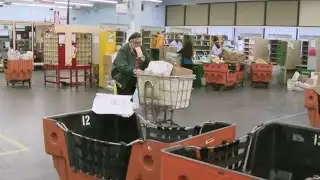 Postal workers battle the last minute holiday rush