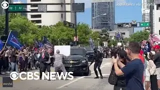Protester detained after rushing Trump