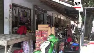 Residents clean up as volcano continues to spew smoke