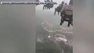 Riders left dangling above amusement park as storm hits