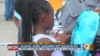 School-aged children get backpacks