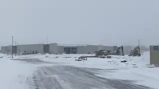 Snow blows over Costco construction site