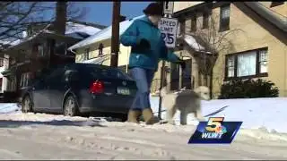 Snow-covered sidewalks causing many pedestrians to walk on the streets