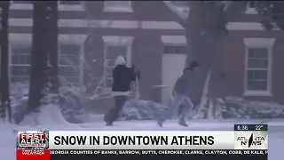 Snow falls in downtown Athens