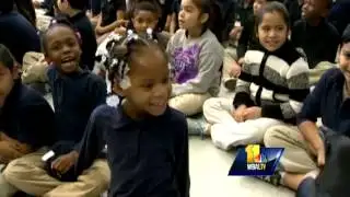 Students squeal over Ravens Purple Caravan visit