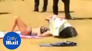 Sunbather spoils wedding pictures by refusing to move from sunspot