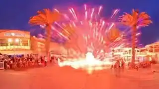 Teens on e-bikes light fireworks on Hermosa Beach Pier