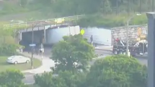 Tractor-trailer stuck under a bridge on St. Paul Street