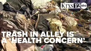 Trash piles in alley for months