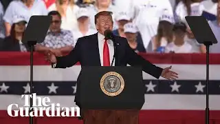 Trump laughs after audience member suggests shooting migrants