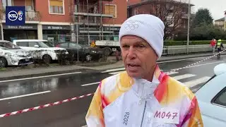 Utah’s David Huntsman carries Olympic torch in rain‑soaked Milan suburb